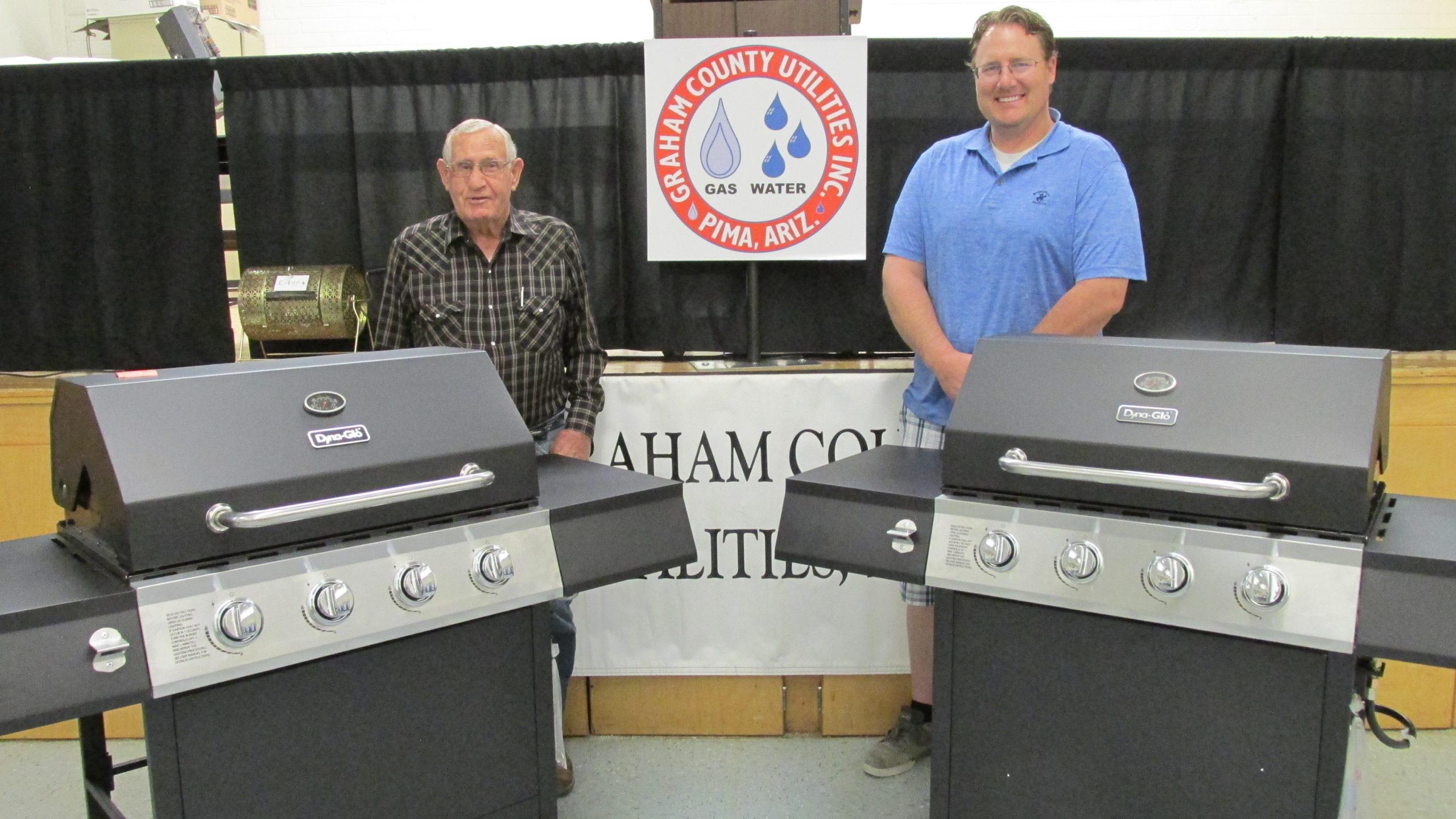 2 GCEC members with their grill prizes